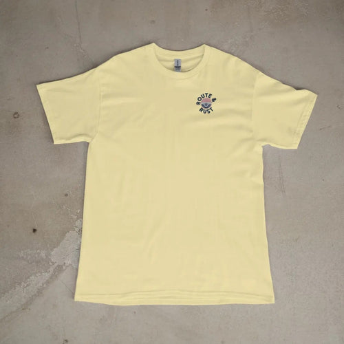 Front of a Butter tee laid flat, with the small Route & Rust logo on the left chest.