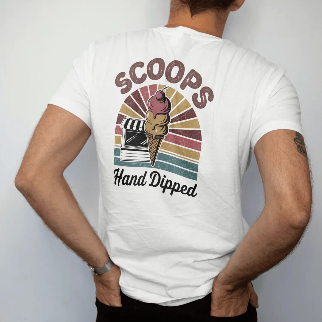 Man wearing a White tee, seen from the back: a triple-scoop cone in front of a walk-up ice cream stand, with "SCOOPS" and "HAND DIPPED" in chunky 70s lettering and brush script, printed in faded, cracked brown, rust red, mustard and dusty teal over…