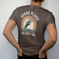 Man wearing a Espresso tee, seen from the back: an oversized vintage spark plug crackling with lightning, with "SPARK PLUGS" and "FIRE EVERY TIME" in chunky 70s lettering and small 70s caps, printed in faded, cracked cream, mustard, burnt orange…
