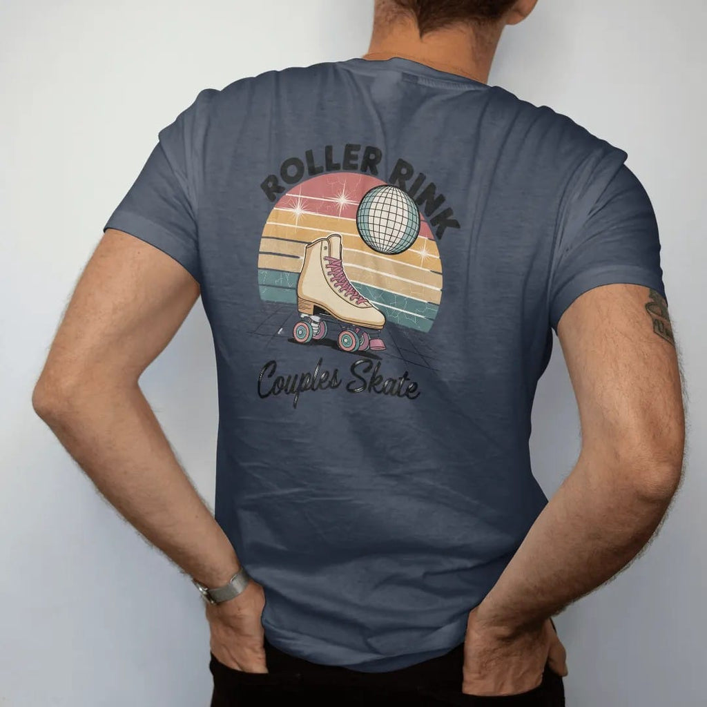 Man wearing a Midnight tee, seen from the back: a vintage roller skate with rainbow wheels under disco sparkles, with "ROLLER RINK" and "COUPLES SKATE" in chunky 70s lettering and brush script, printed in faded, cracked cream, mustard, burnt orange…
