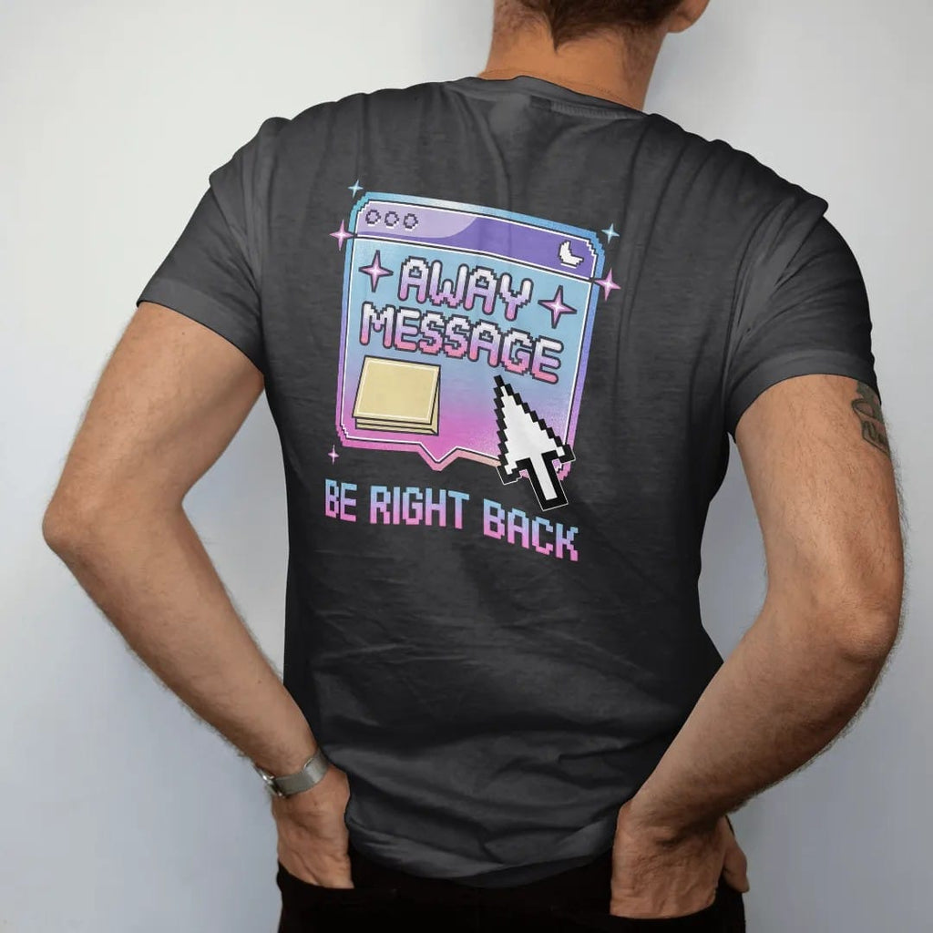 Man wearing a Black tee, seen from the back: a beveled pop-up chat window with a sticky note and sleeping moon, with "AWAY MESSAGE" and "BE RIGHT BACK" in liquid-chrome bubble letters and small pixel type, printed in glossy gunmetal chrome, cobalt,…