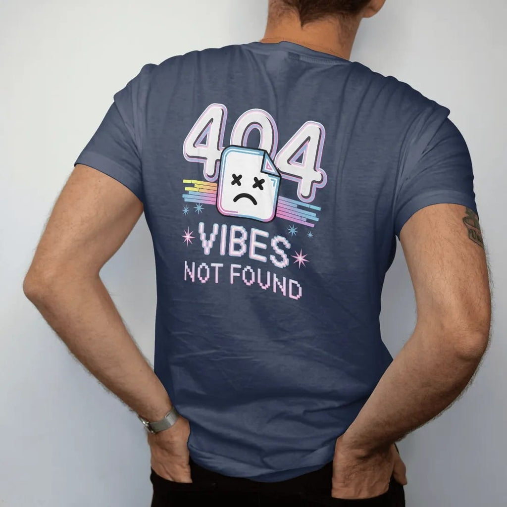 Man wearing a Navy tee, seen from the back: a broken-page icon with a sad pixel face and glitchy numerals, with "404" and "VIBES NOT FOUND" in liquid-chrome bubble letters and small pixel type, printed in glossy chrome silver, baby blue, bubblegum…