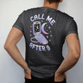 Man wearing a Black tee, seen from the back: an open silver flip phone with a moon on its screen, with "CALL ME" and "AFTER 9" in liquid-chrome bubble letters and small pixel type, printed in glossy gunmetal chrome, cobalt, hot magenta and violet…