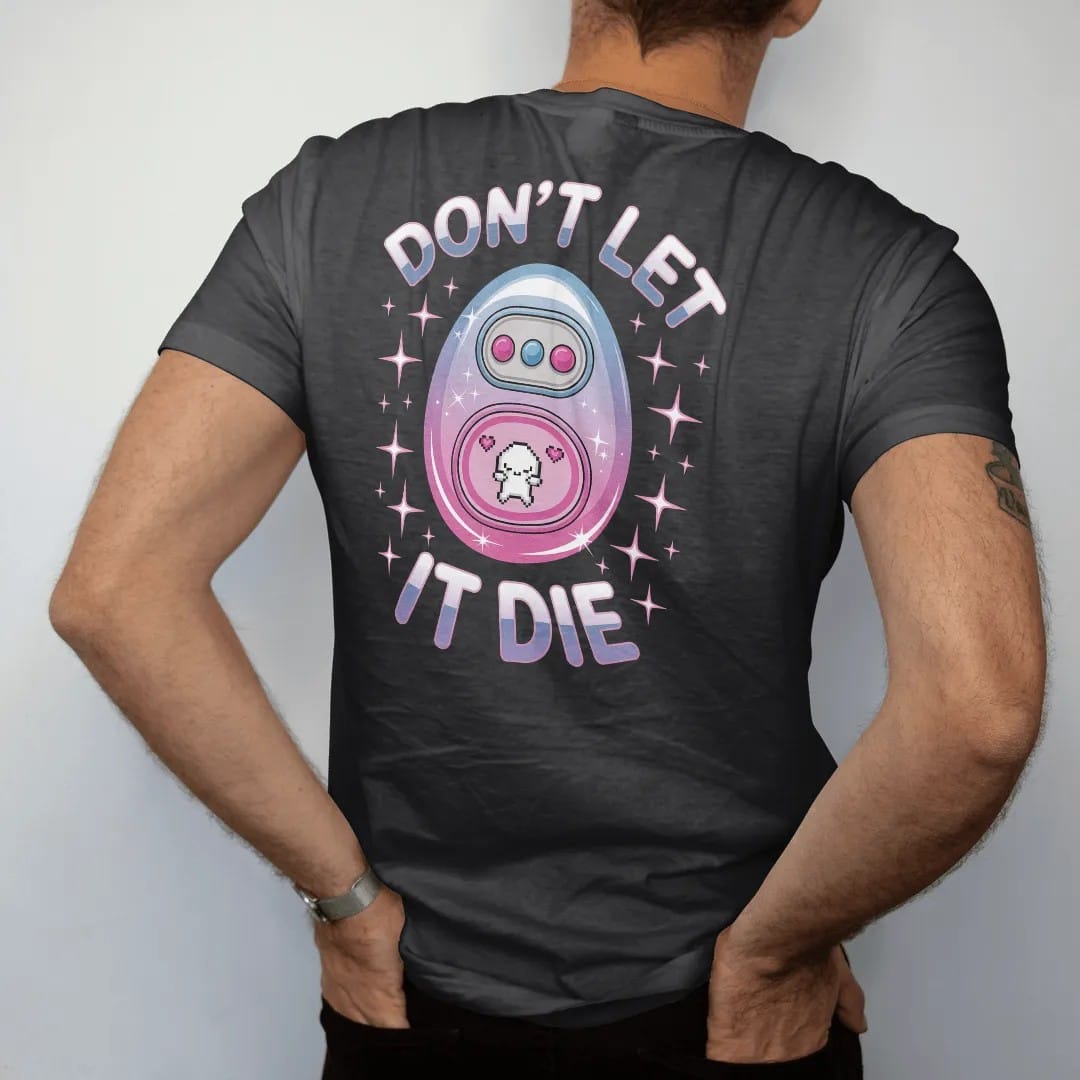 Man wearing a Black tee, seen from the back: an egg-shaped keychain digital pet with a crying pixel creature, with "DON'T LET" and "IT DIE" in liquid-chrome bubble letters and small pixel type, printed in glossy gunmetal chrome, cobalt, hot magenta…