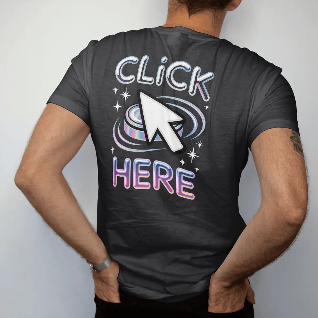 Man wearing a Black tee, seen from the back: an oversized pixel cursor clicking a glossy beveled button, with "CLICK" and "HERE" in liquid-chrome bubble letters and small pixel type, printed in glossy chrome silver, baby blue, bubblegum pink and…