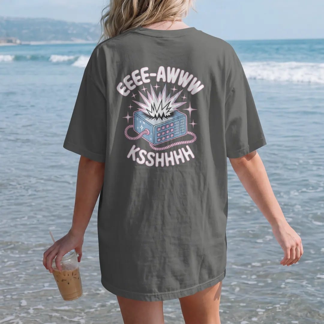 Woman on the beach in a Pepper tee, back view: a jagged sound-wave burst exploding from a modem, with "EEEE-AWWW" and "KSSHHHH" in liquid-chrome bubble letters and small pixel type, printed in glossy chrome silver, baby blue, bubblegum pink and…