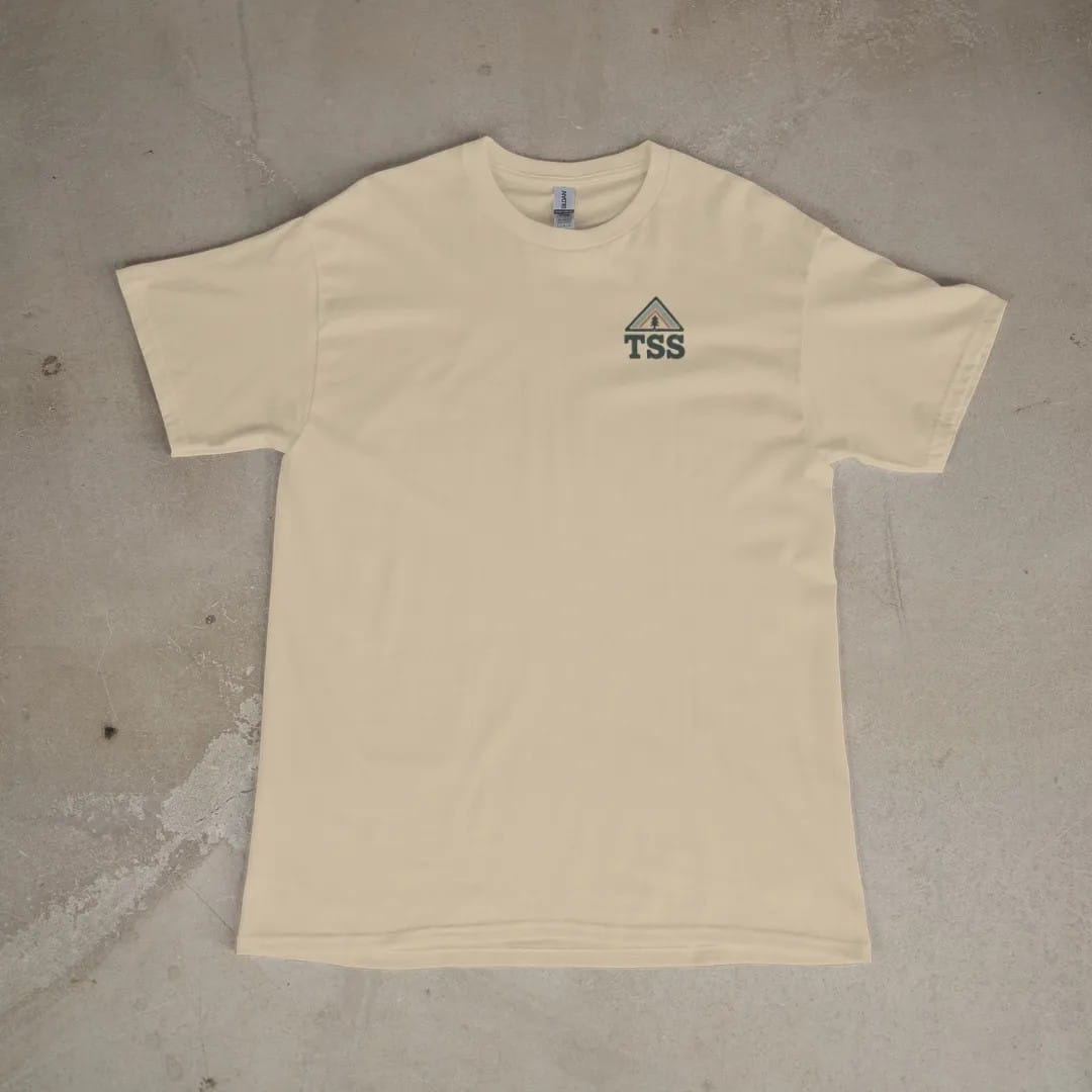 Front of a Sandstone tee laid flat, with the small Trailhead Standard logo on the left chest.
