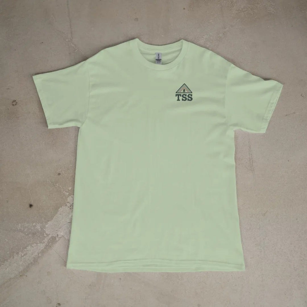 Front of a Light Green tee laid flat, with the small Trailhead Standard logo on the left chest.