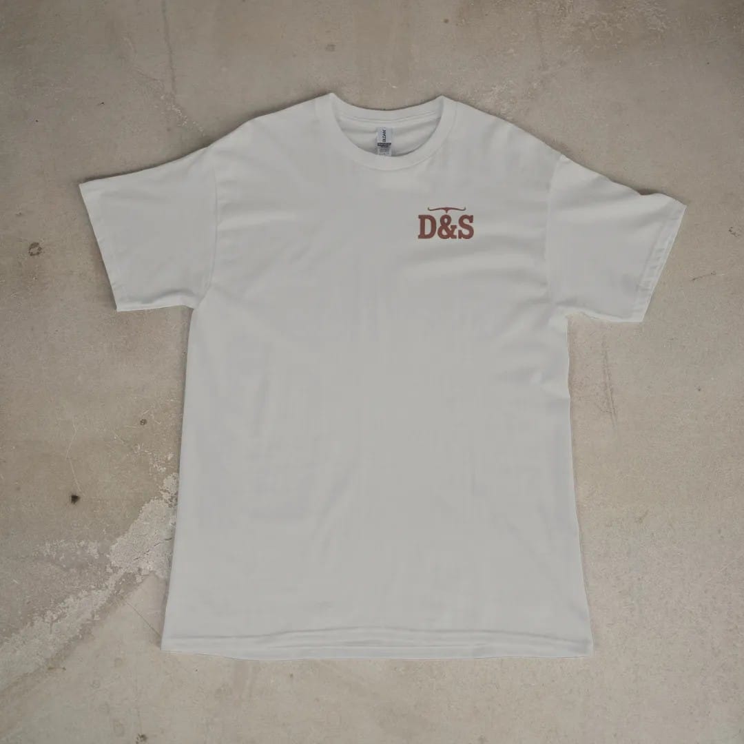 Front of a Granite tee laid flat, with the small Dust & Spur logo on the left chest.