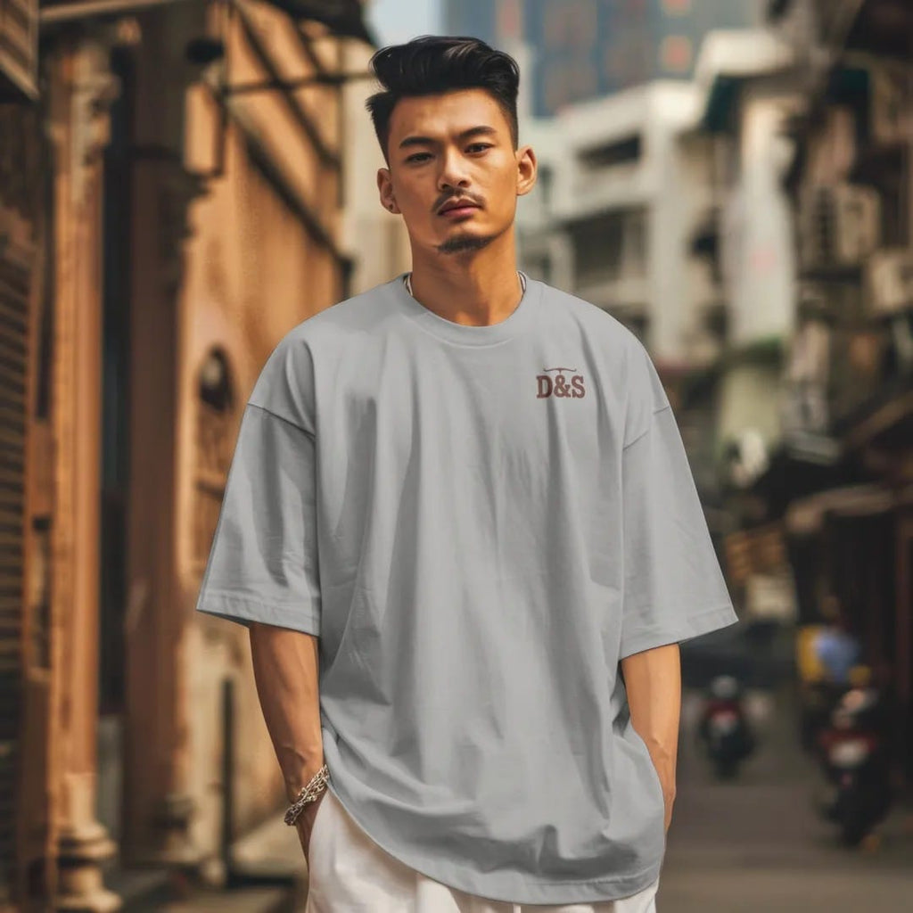 Man in a Granite tee on a city street, with the small Dust & Spur logo on the left chest.