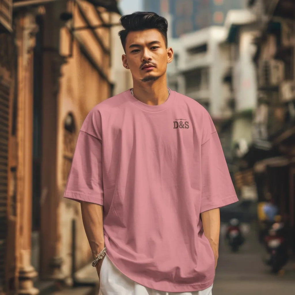 Man in a Watermelon tee on a city street, with the small Dust & Spur logo on the left chest.
