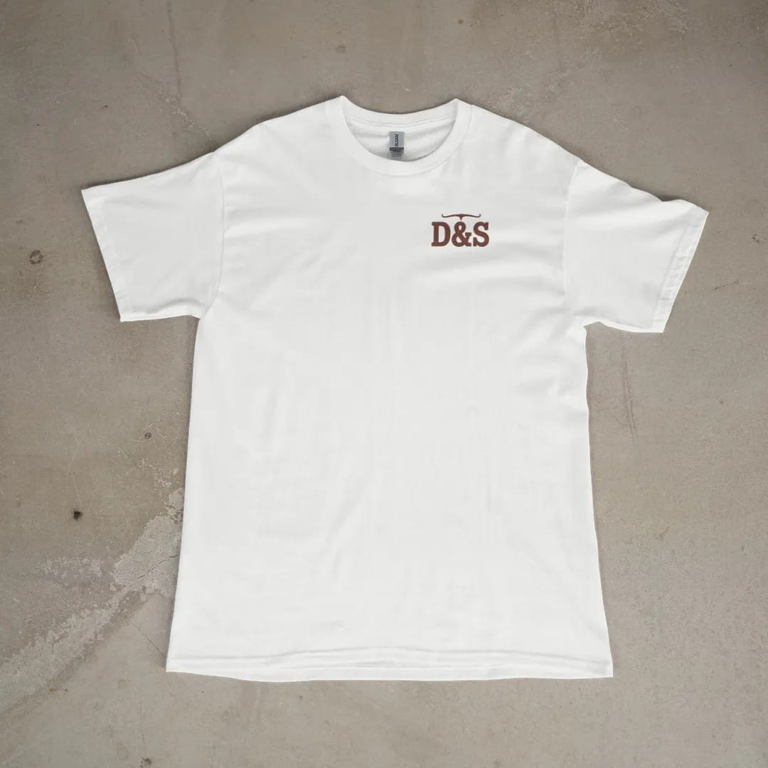 Front of a White tee laid flat, with the small Dust & Spur logo on the left chest.