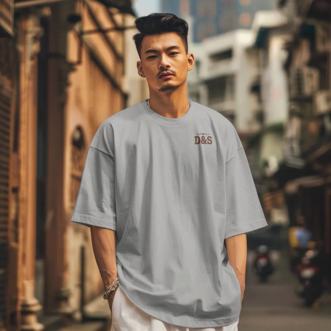 Man in a Granite tee on a city street, with the small Dust & Spur logo on the left chest.