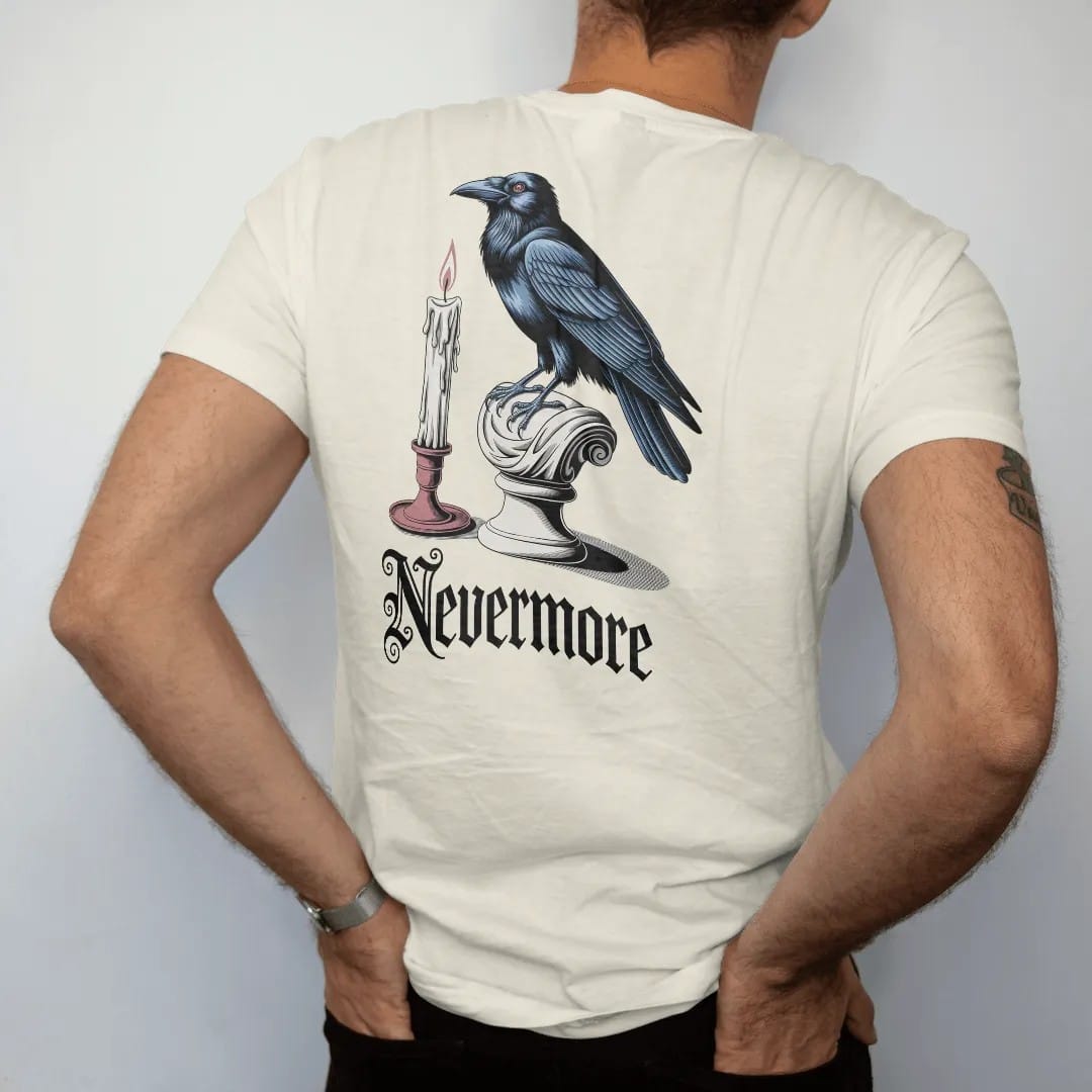 Man wearing a Ivory tee, seen from the back: back print: raven perched on a classical marble bust beside a guttering candle, detailed Victorian engraving style, "NEVERMORE" below in ornate gothic blackletter, printed in bone cream, antique gold and…