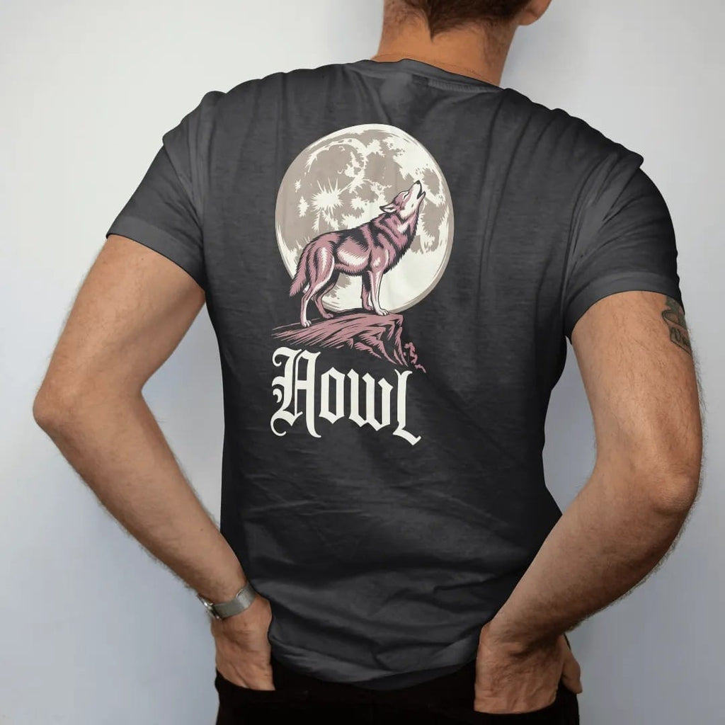 Man wearing a Black tee, seen from the back: back print: lone wolf howling on a rocky ridge in front of a huge full moon, detailed Victorian engraving with stippling, "HOWL" below in ornate gothic blackletter, printed in bone cream, antique gold…