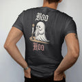 Man wearing a Black tee, seen from the back: back print: little sheet ghost crying into a lace handkerchief by candlelight, playful Victorian engraving style, "BOO" above in ornate gothic blackletter, "HOO" below in thin copperplate script, printed…