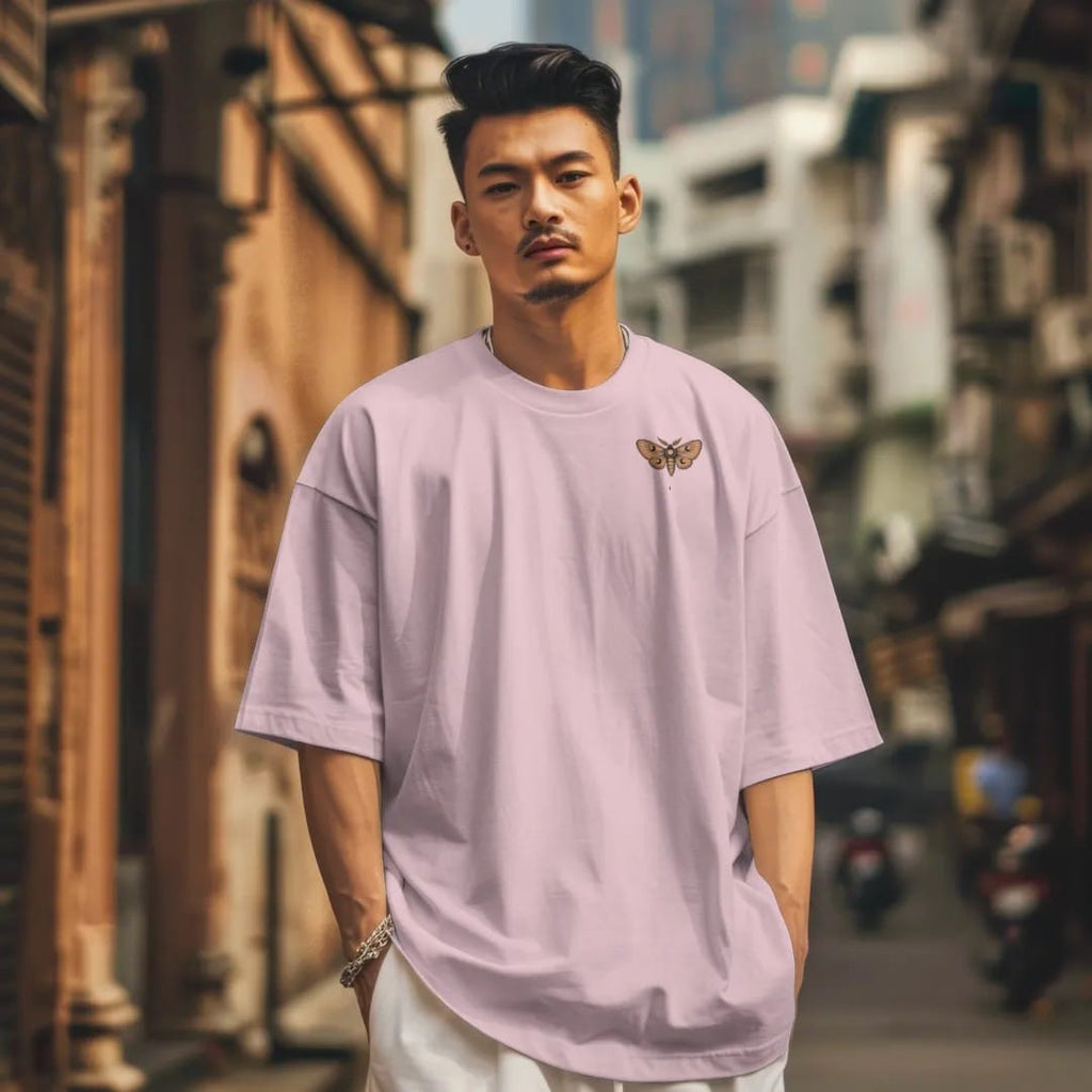 Man in a Blossom tee on a city street, with the small Nocturne logo on the left chest.
