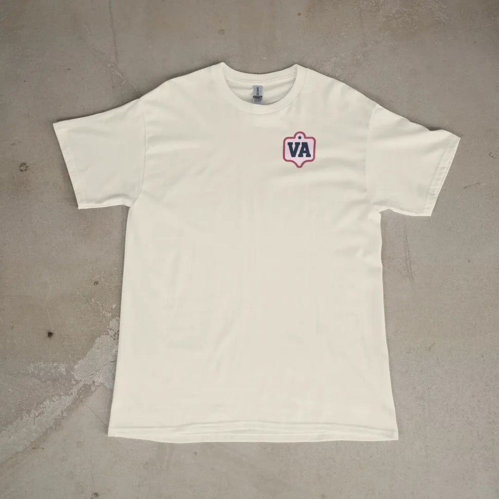 Front of a Ivory tee laid flat, with the small Varsity Archive logo on the left chest.