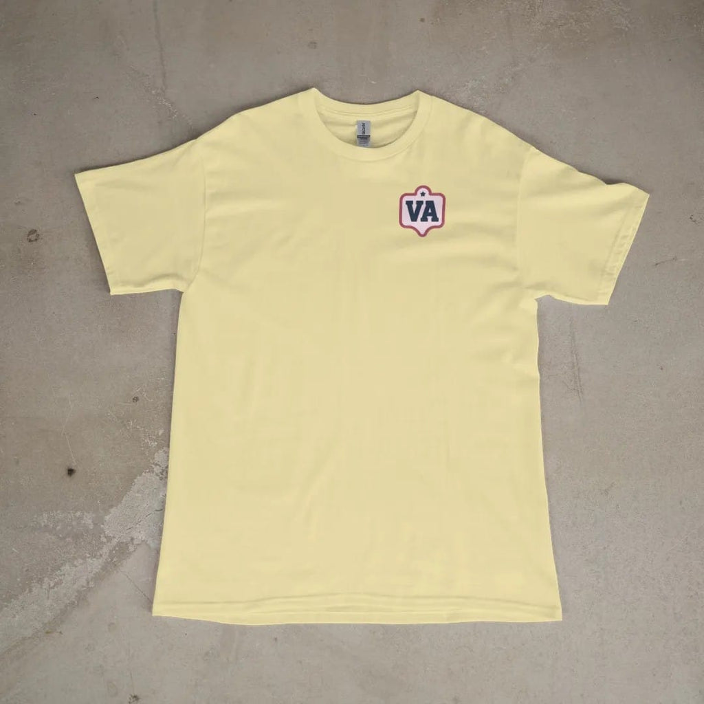 Front of a Butter tee laid flat, with the small Varsity Archive logo on the left chest.