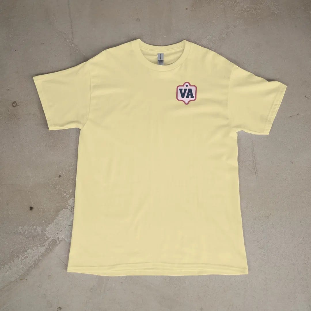 Front of a Butter tee laid flat, with the small Varsity Archive logo on the left chest.