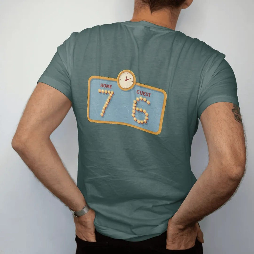 Man wearing a Blue Spruce tee, seen from the back: a vintage light-bulb scoreboard with a small clock, with "HOME 7" and "GUEST 6" in light-bulb scoreboard digits, printed in faded bleacher cream, mustard gold, washed red and dusty sky blue with a…