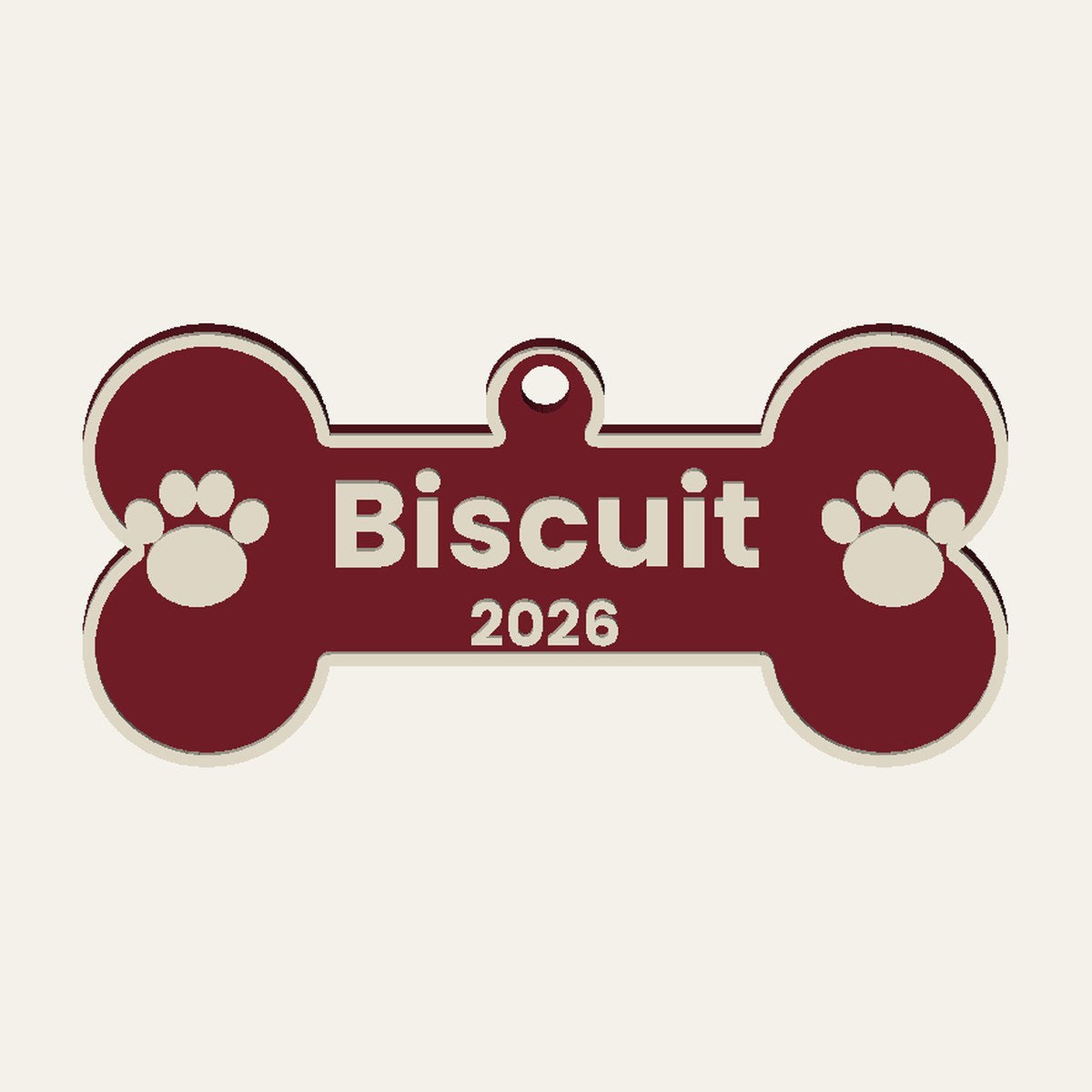 Render of a cranberry dog bone ornament with the name Biscuit, 2026 and paw prints