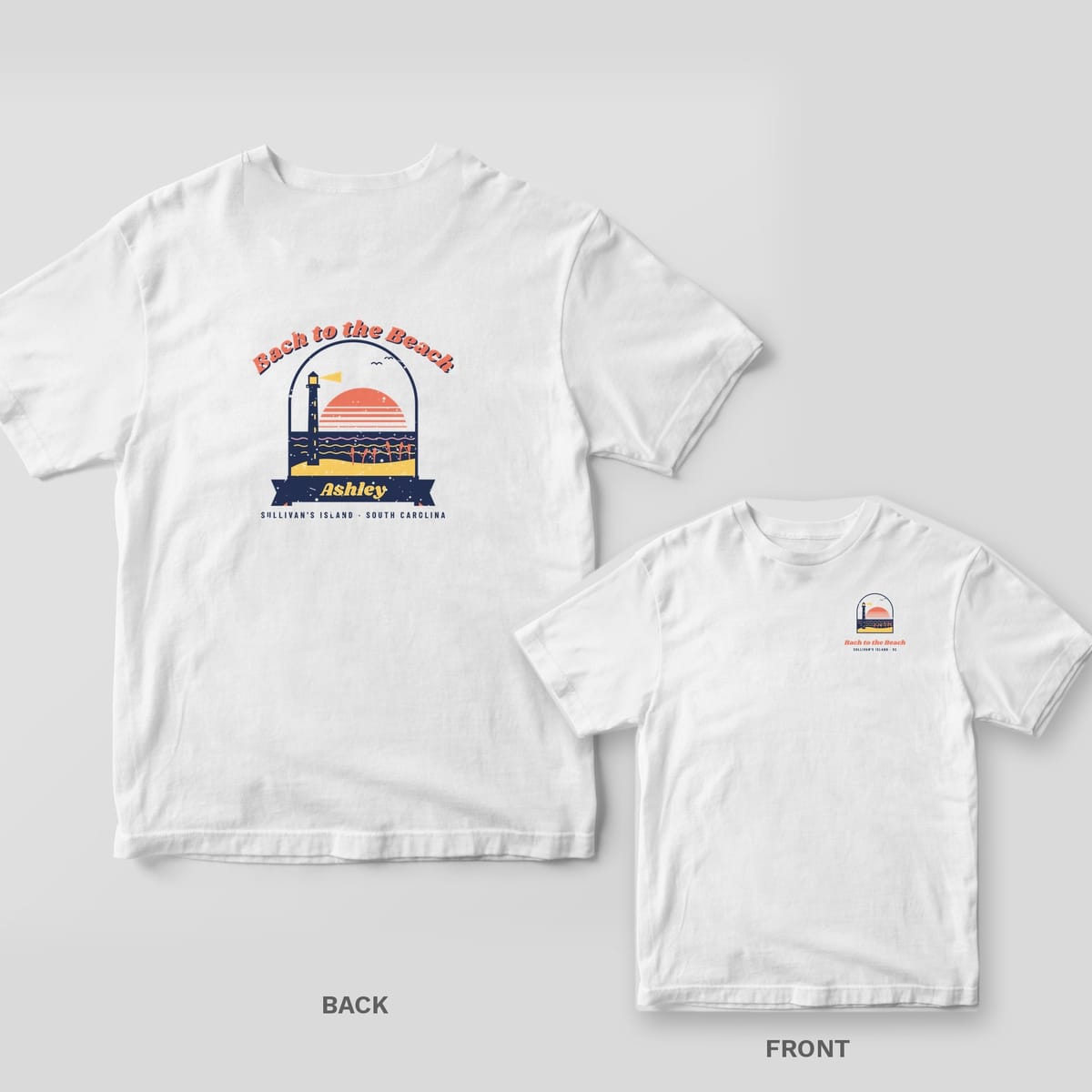 White Comfort Colors tee with a retro back print of a sunset, waves and the Sullivan's Island lighthouse in an arched window, Bach to the Beach, and Ashley on a ribbon.