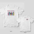 White Comfort Colors tee with a back print of pastel Charleston row houses, Bach on the Row script and Ashley on a hanging sign, plus an inset of the chest print.