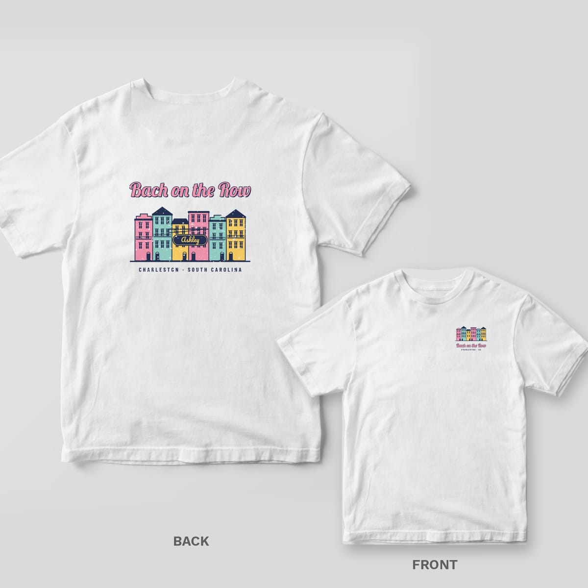 White Comfort Colors tee with a back print of pastel Charleston row houses, Bach on the Row script and Ashley on a hanging sign, plus an inset of the chest print.