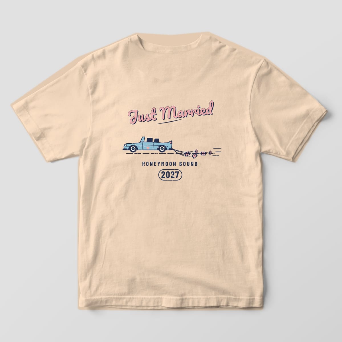 Back of an Ivory Comfort Colors tee: Just Married script over a vintage getaway car dragging tin cans and shells, HONEYMOON BOUND 2027