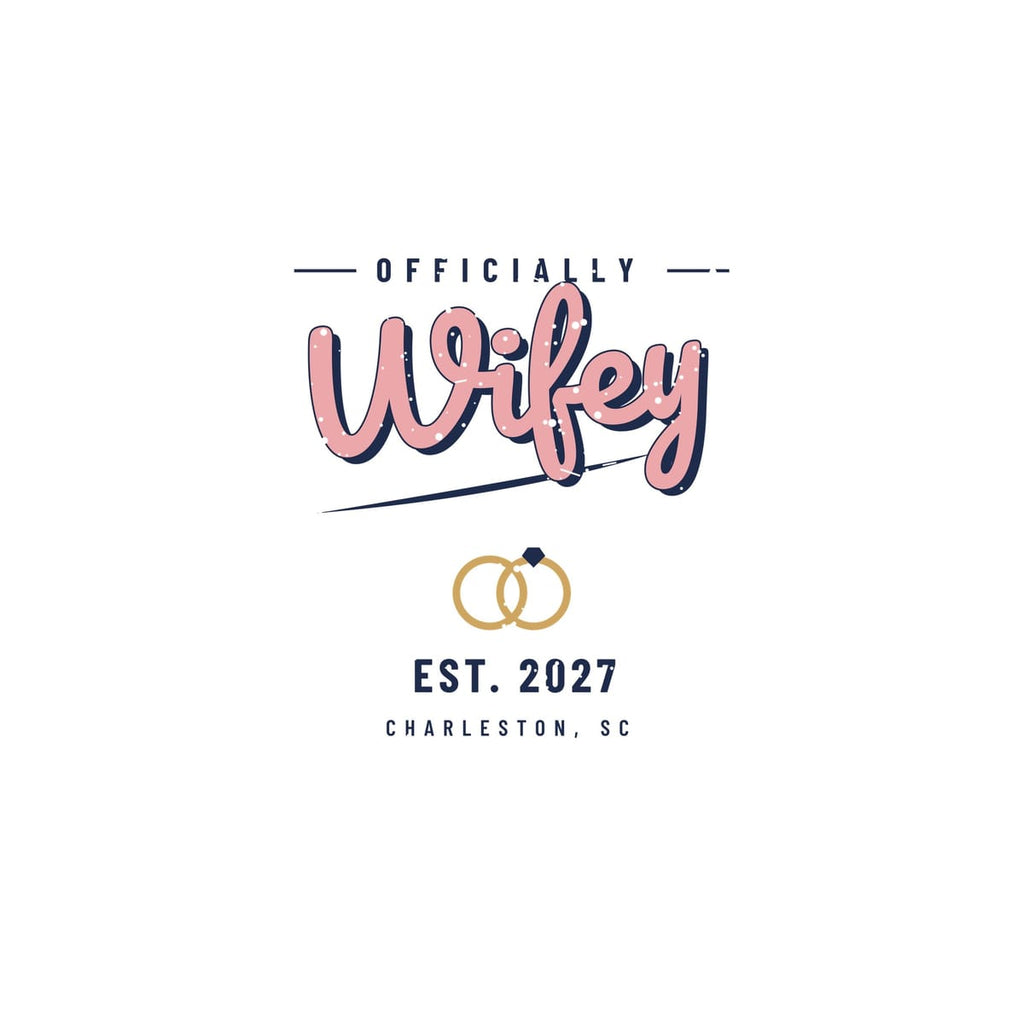 Close-up of the pink Wifey lettering with navy shadow, swoosh underline and interlocked rings with a stone